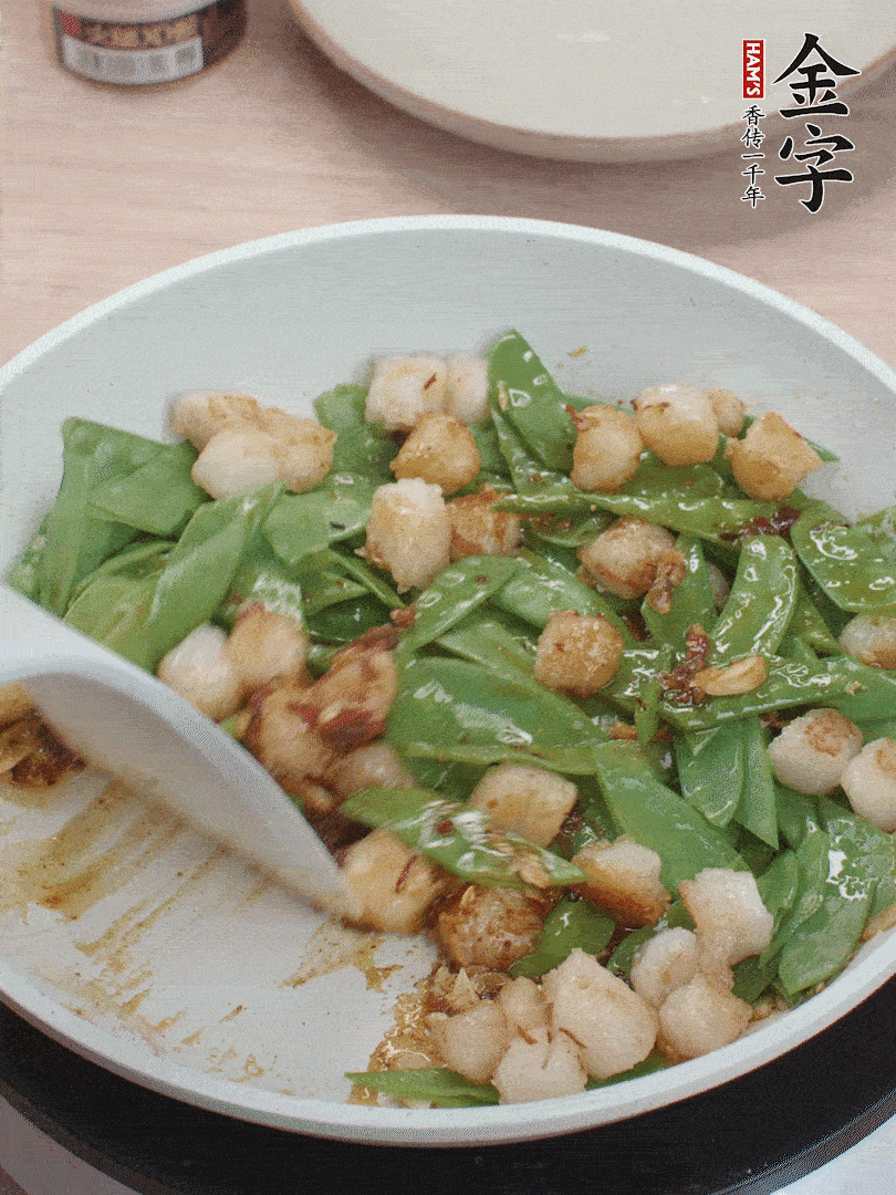 下甜豆莢、鮮貝輕輕翻炒均勻。