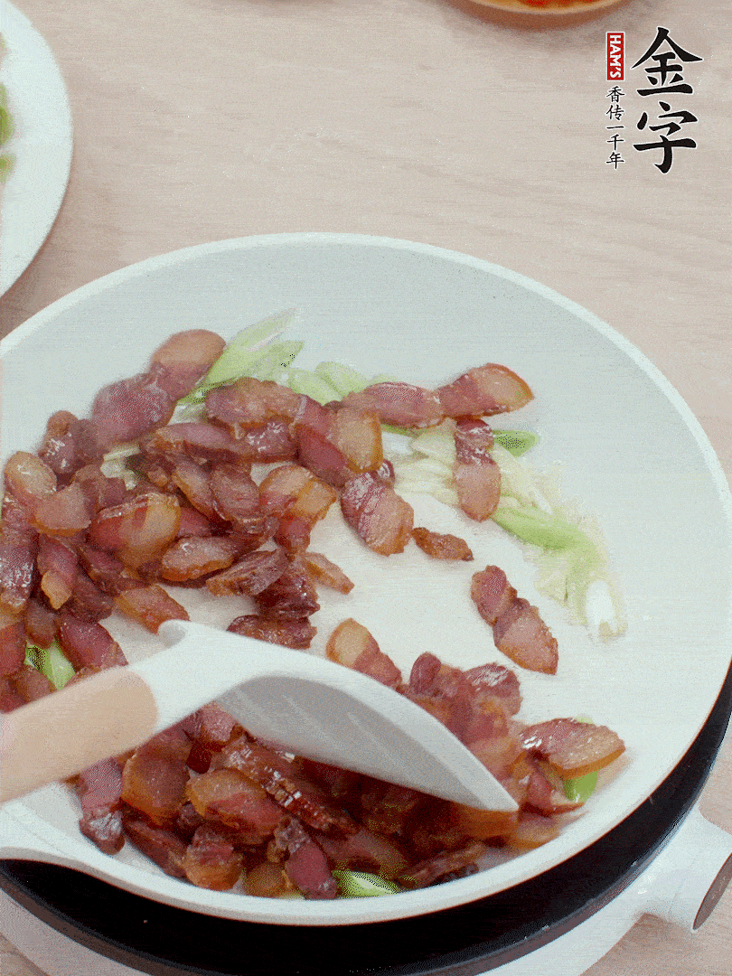 鍋中少許油，姜、蒜白爆香，下臘肉煸出油脂。